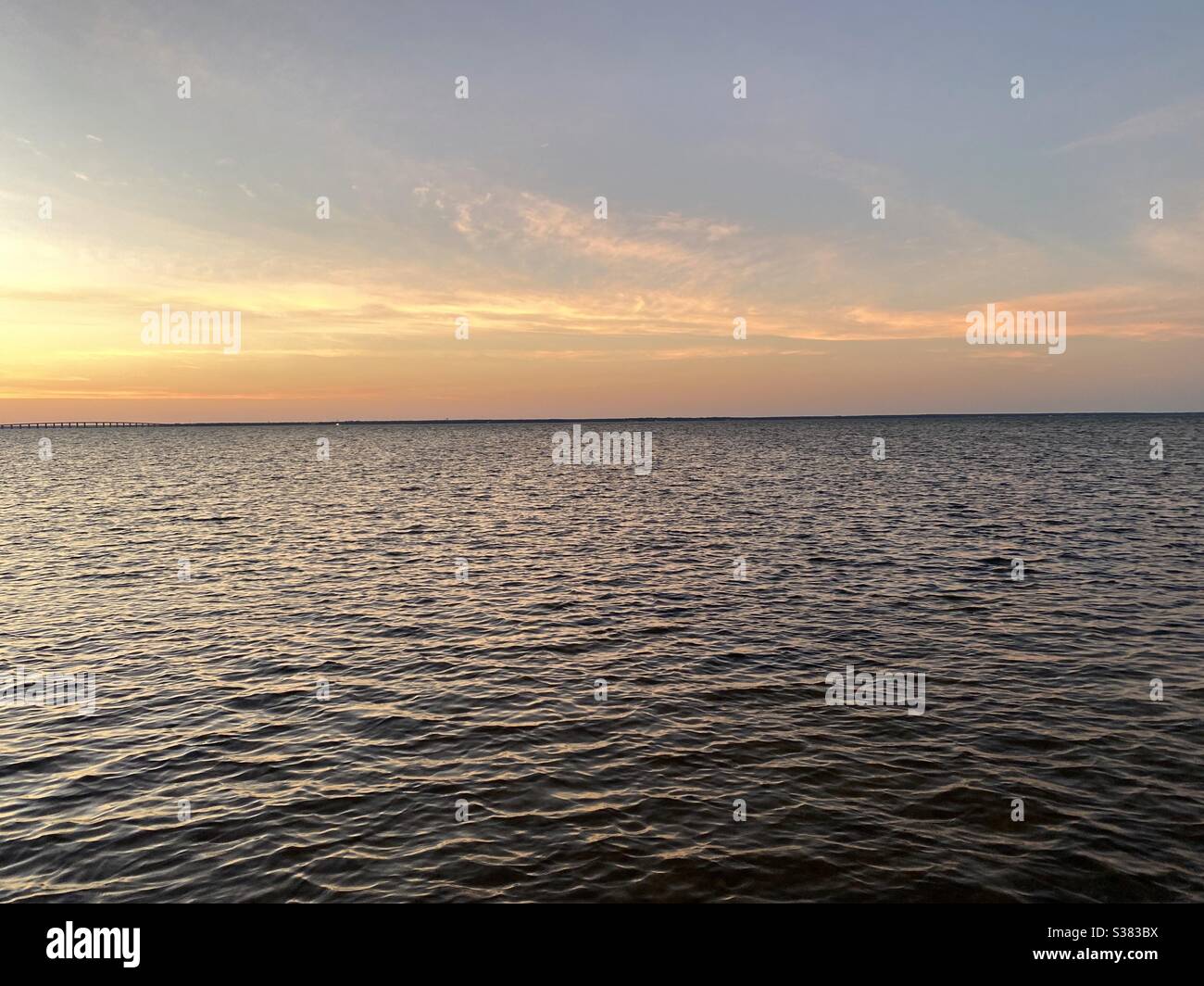 Golden sunset skies over bay water Stock Photo - Alamy