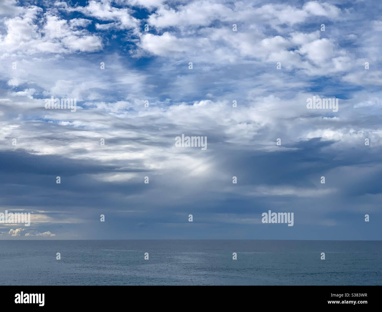 Blue sky and storm clouds over the ocean , blue sea and horizon - Smartphone Captured Stock Image
