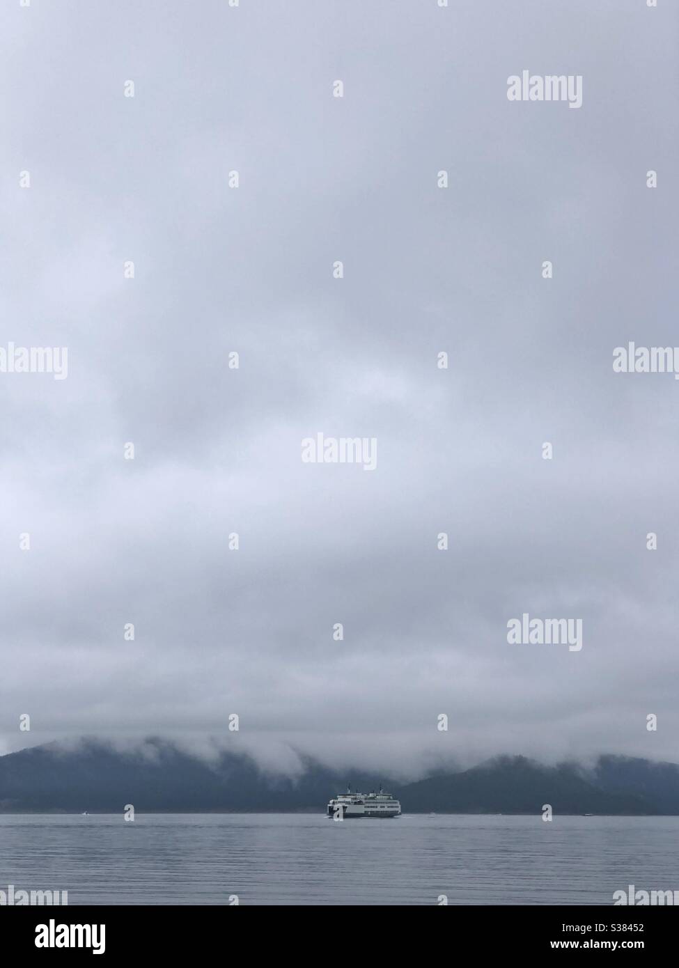 Ferry arrives to Anacortes in the fog from San Juan Islands in summer 2020 Stock Photo