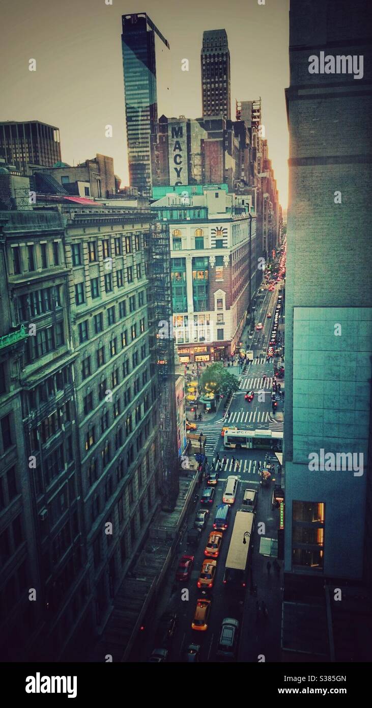 A photograph from a rooftop looking down midtown New York at Macy’s store, traffic and pedestrians. New York bustle. - Smartphone Captured Stock Image