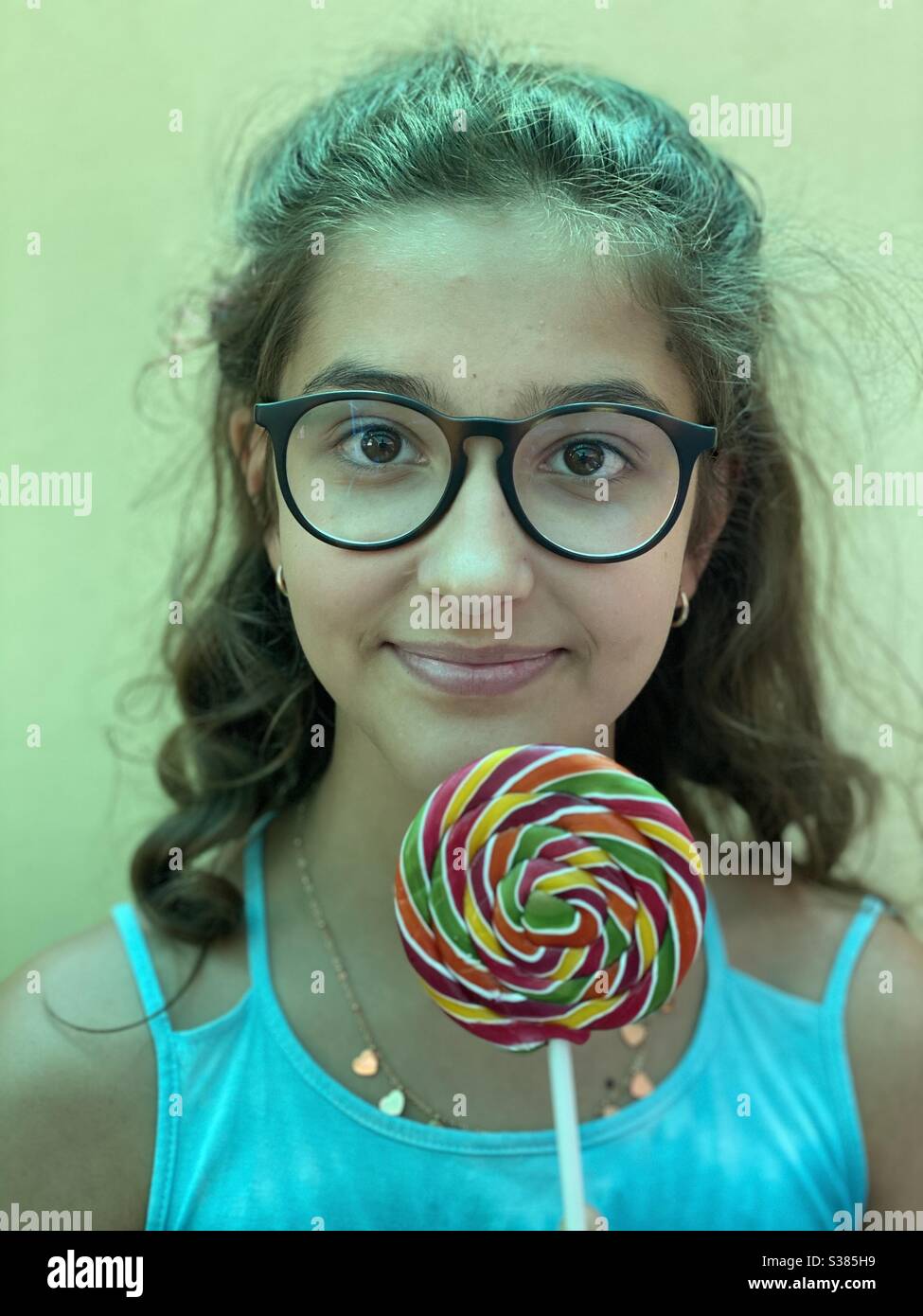 Teen portrait with a colorful candy - Smartphone Captured Stock Image
