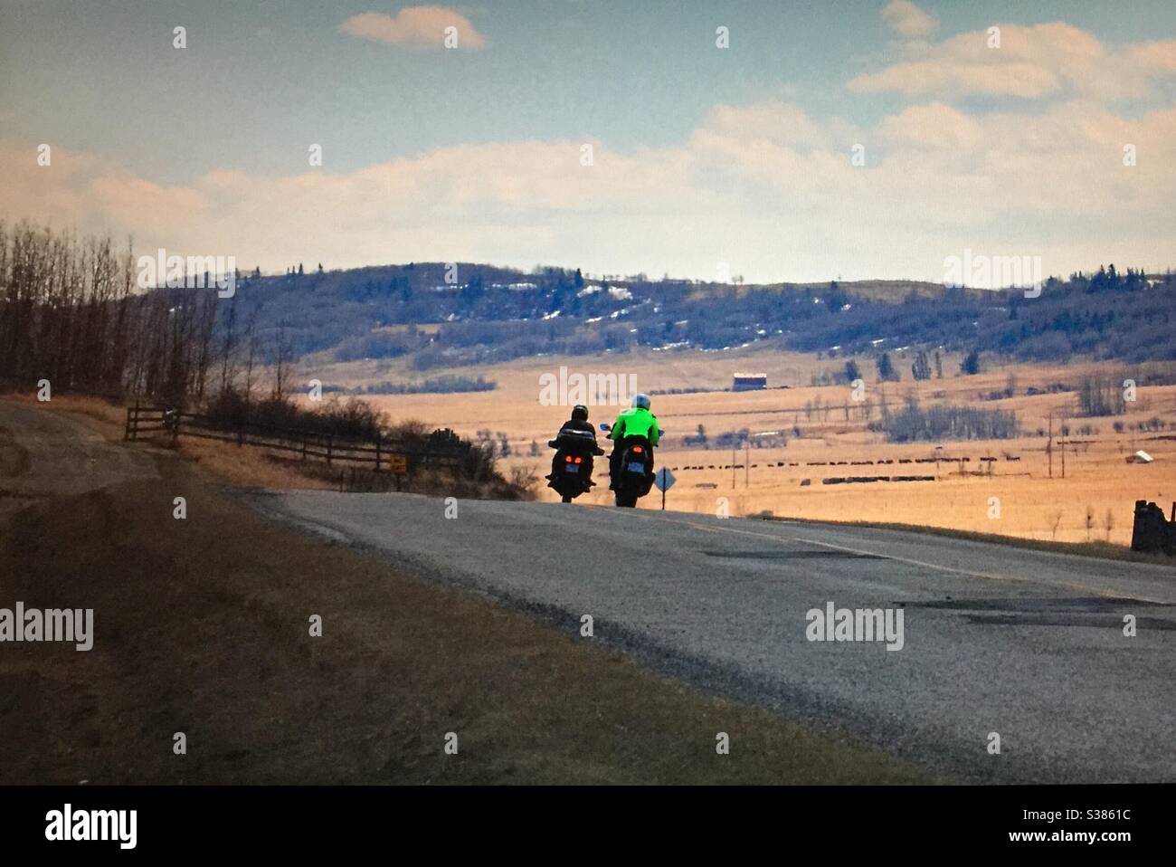Two bikers, motorcycles, riding, foothills of the Canadian Rockies , Alberta, Canada , recreational, scenic, landscape - Smartphone Captured Stock Image