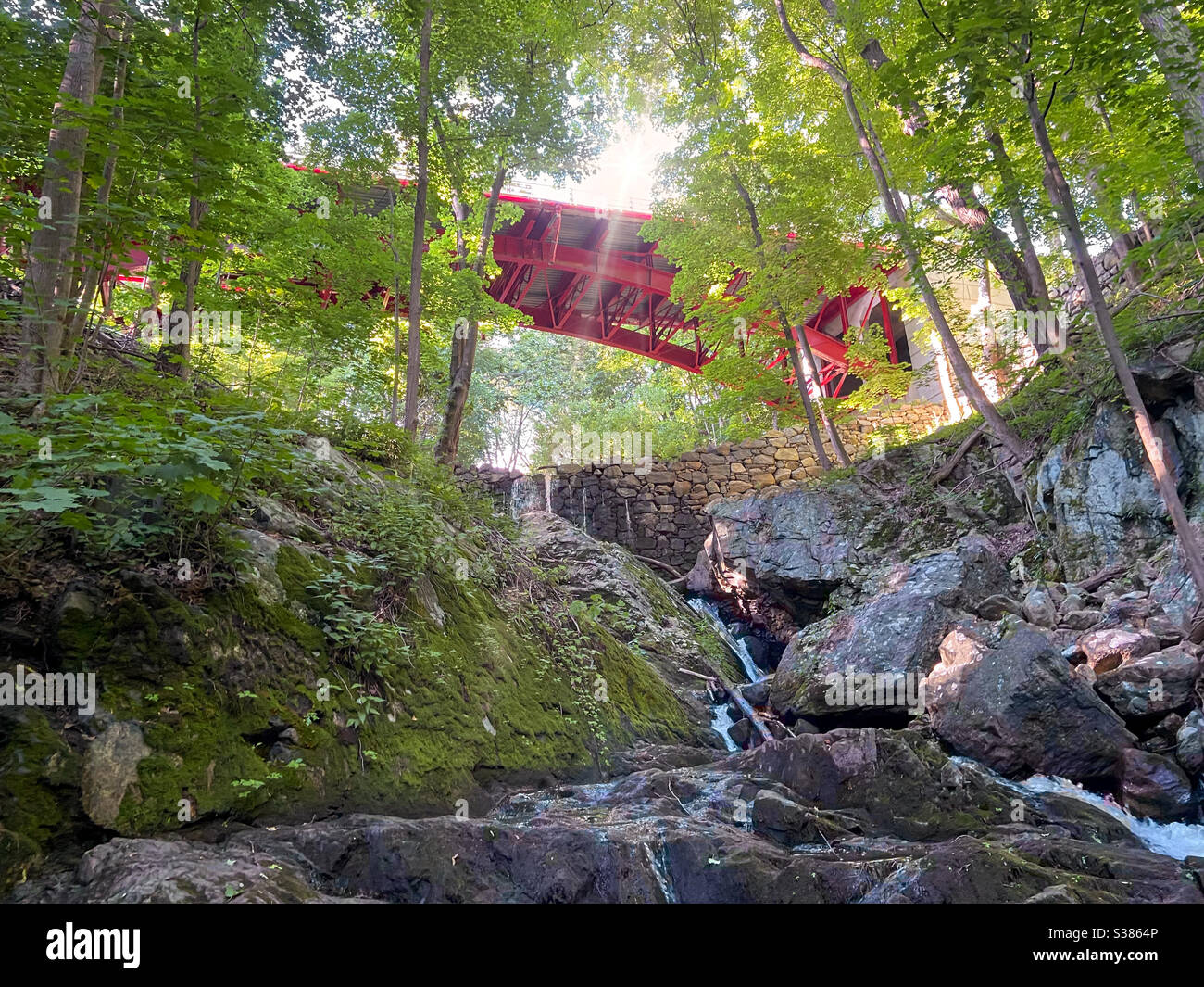 Red bridge over Foundry Brook and waterfall on a beautiful sunny summer day, Hudson Valley Cold Spring Nee York. - Smartphone Captured Stock Image