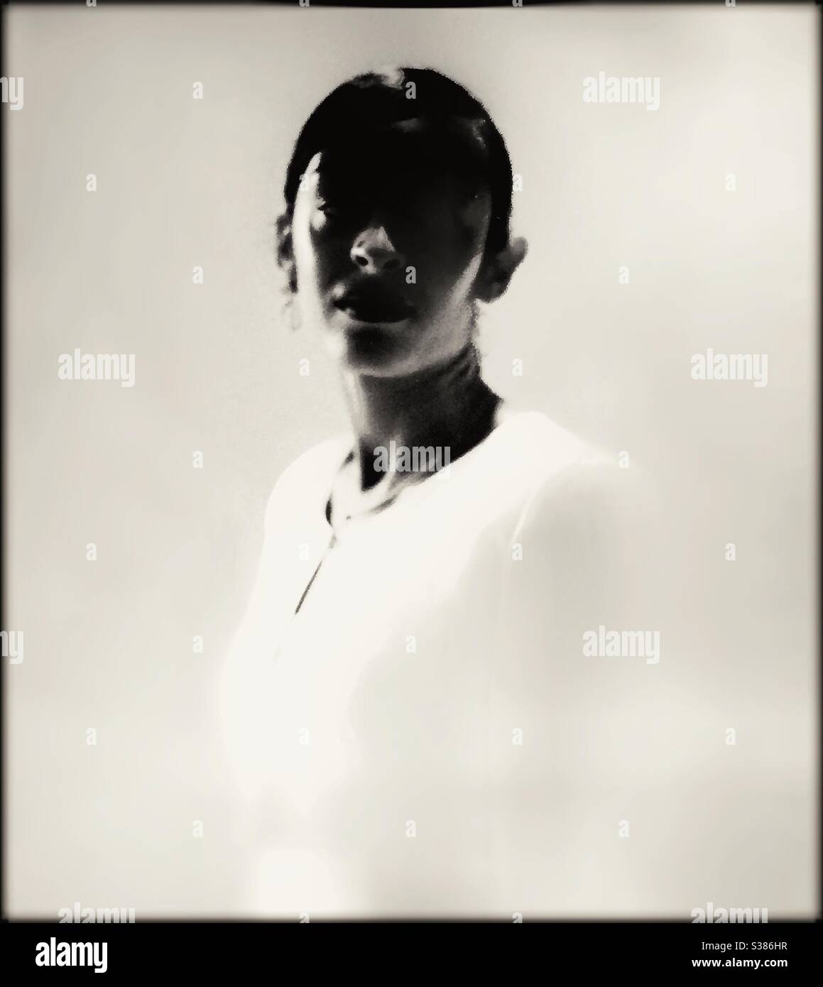 Portrait of a young lady’s face in shadow. - Smartphone Captured Stock Image