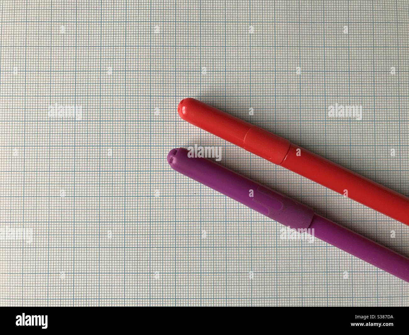 Two Coloured Pencils on a Graph Paper Stock Photo