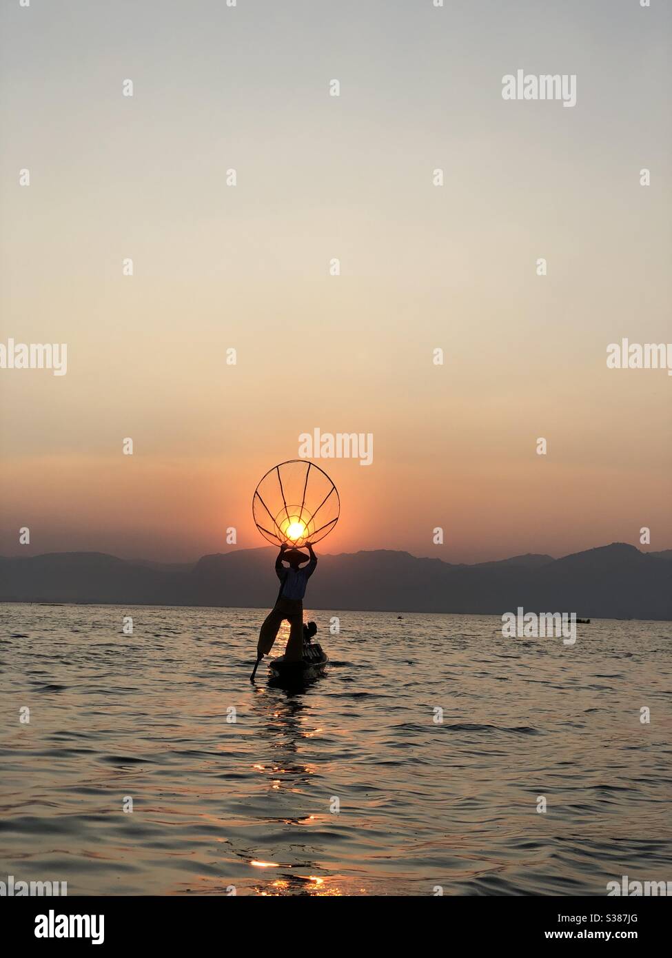 Fishermen and sunset Stock Photo
