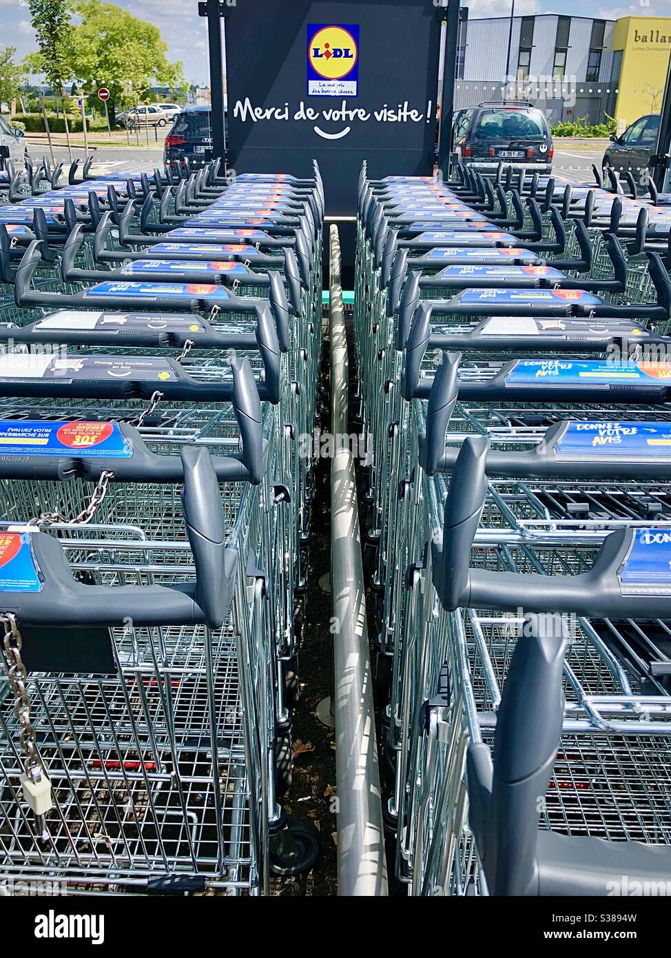 Rows of interlinked LIDL supermarket trolleys. - Smartphone Captured Stock Image