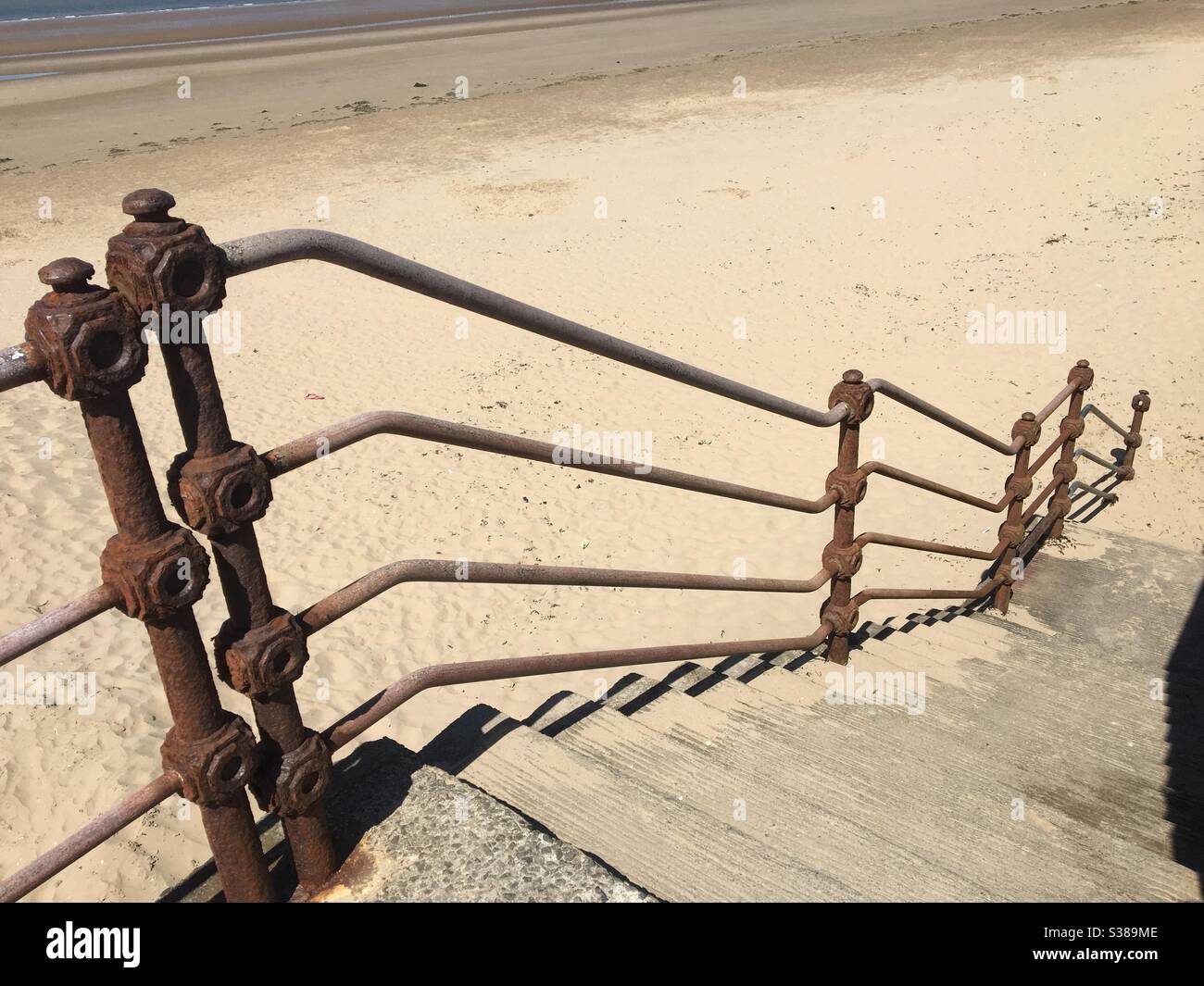 Stairway to heaven. Steps down to the beach.with wrought iron handrails - Smartphone Captured Stock Image