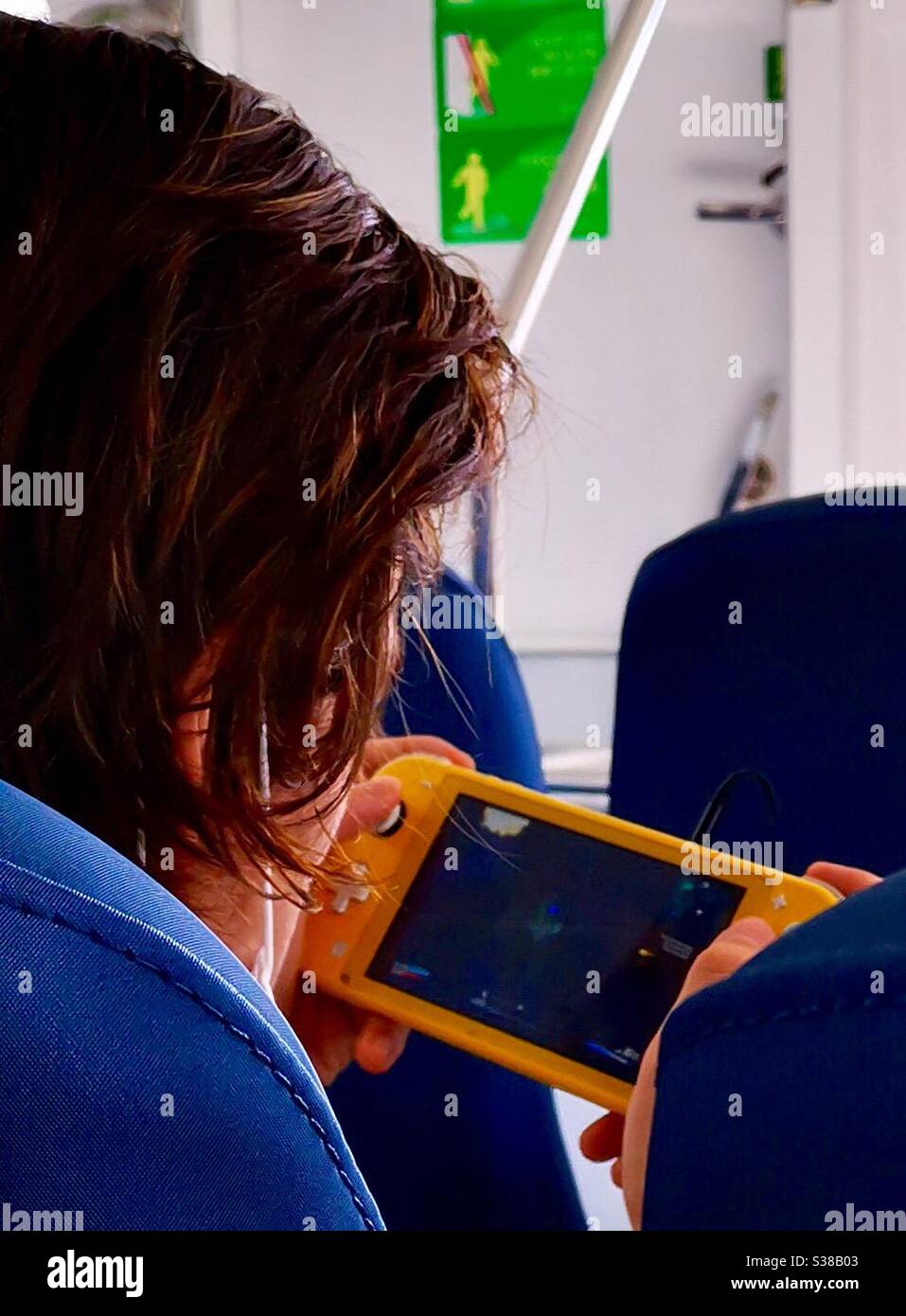 A teenager playing Nintendo switch light. - Smartphone Captured Stock Image