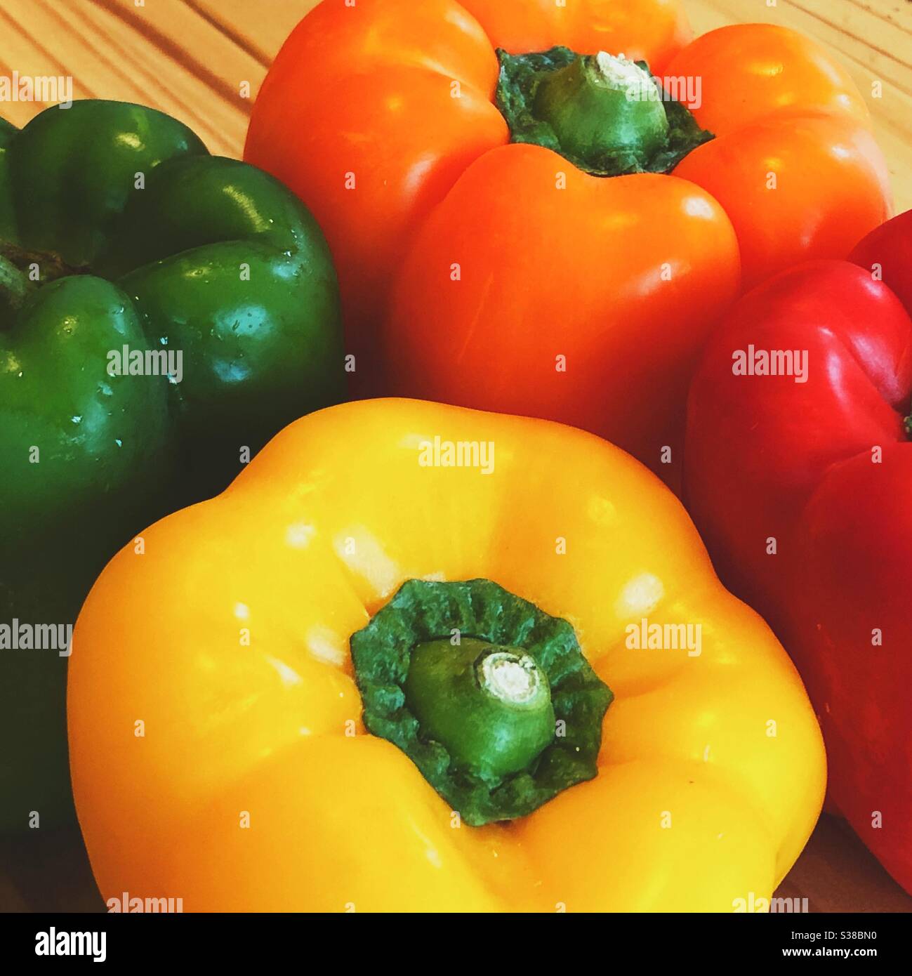 Red, orange, yellow and green bell peppers Stock Photo