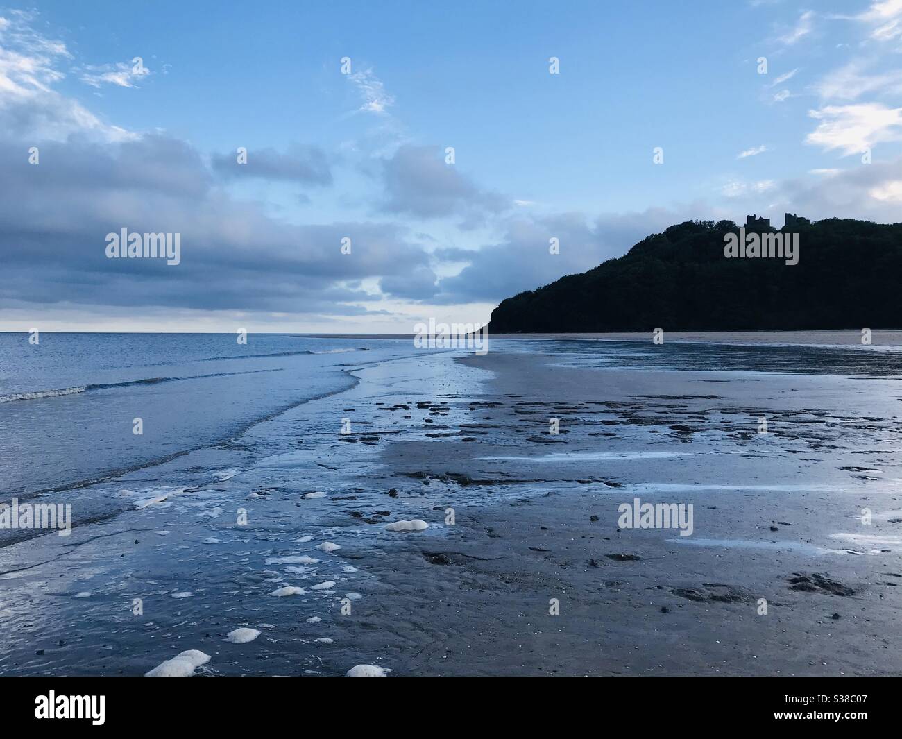 Llansteffan, Carmarthenshire, Wales. 13.7.2020 approx 8pm. The day travel restrictions were lifted in Wales after 3.5 months of lockdown due to COVID-19. Llansteffan Castle to the right on the hill. - Smartphone Captured Stock Image