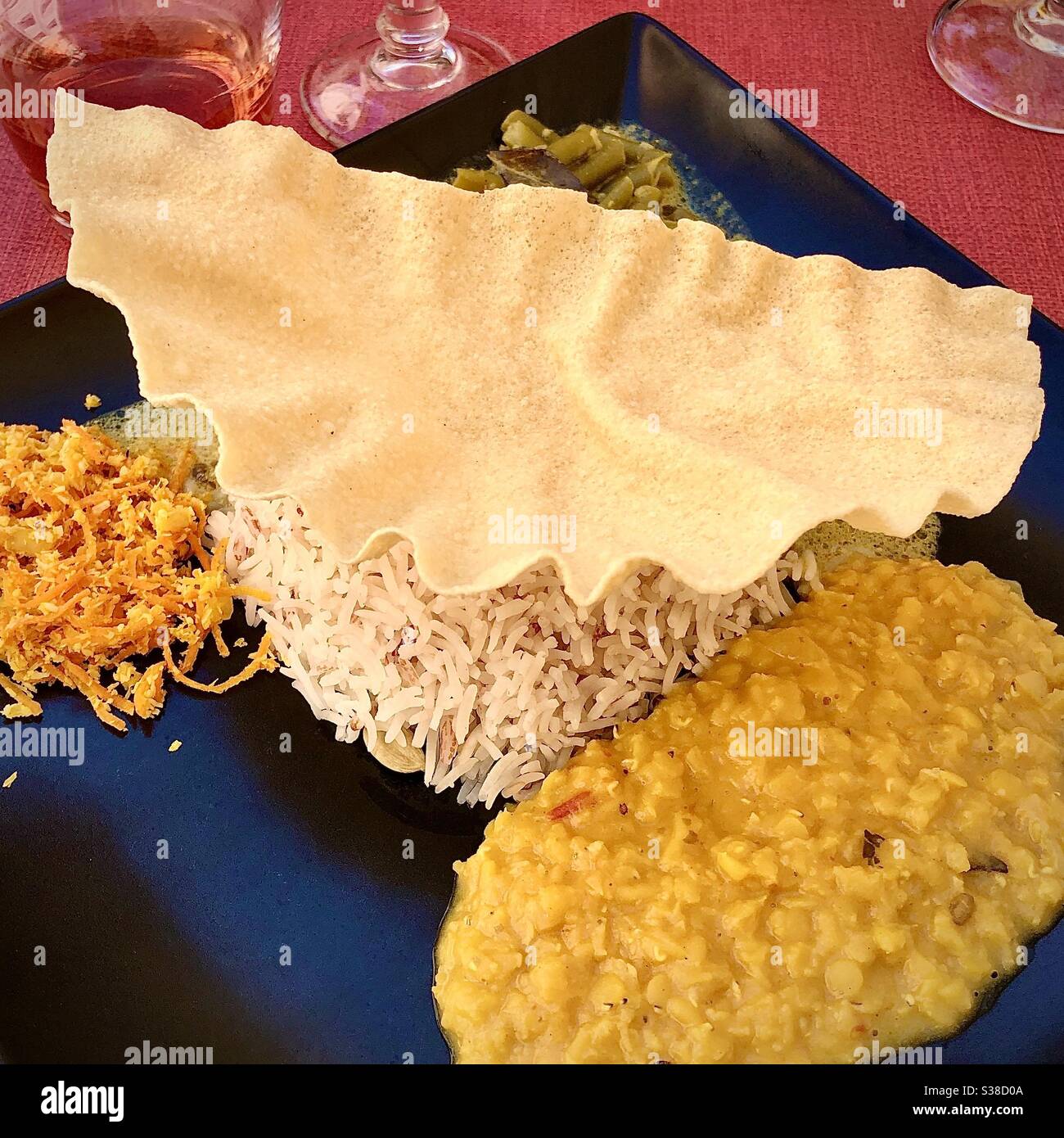 Papadum on traditional vegetarian Indian meal of rice and lentils. - Smartphone Captured Stock Image