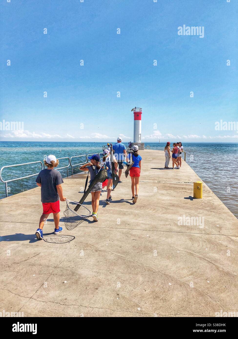 People walking on the pier in Oakville, Ontario, Canada. - Smartphone Captured Stock Image