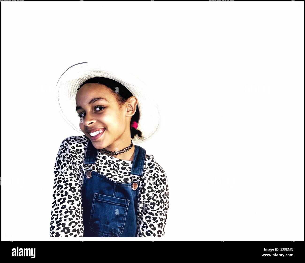 A young mixed race girl smiles at the camera. Stock Photo