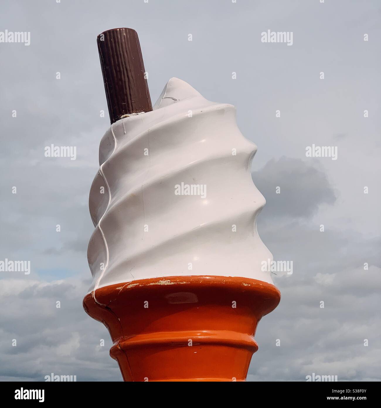 An oversized plastic ice cream cone at the beach - Smartphone Captured Stock Image An oversized plastic ice cream cone at the beach - Smartphone Captured Stock Image
