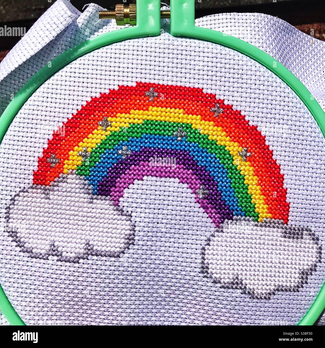 Rainbow and clouds cross stitch. - Smartphone Captured Stock Image