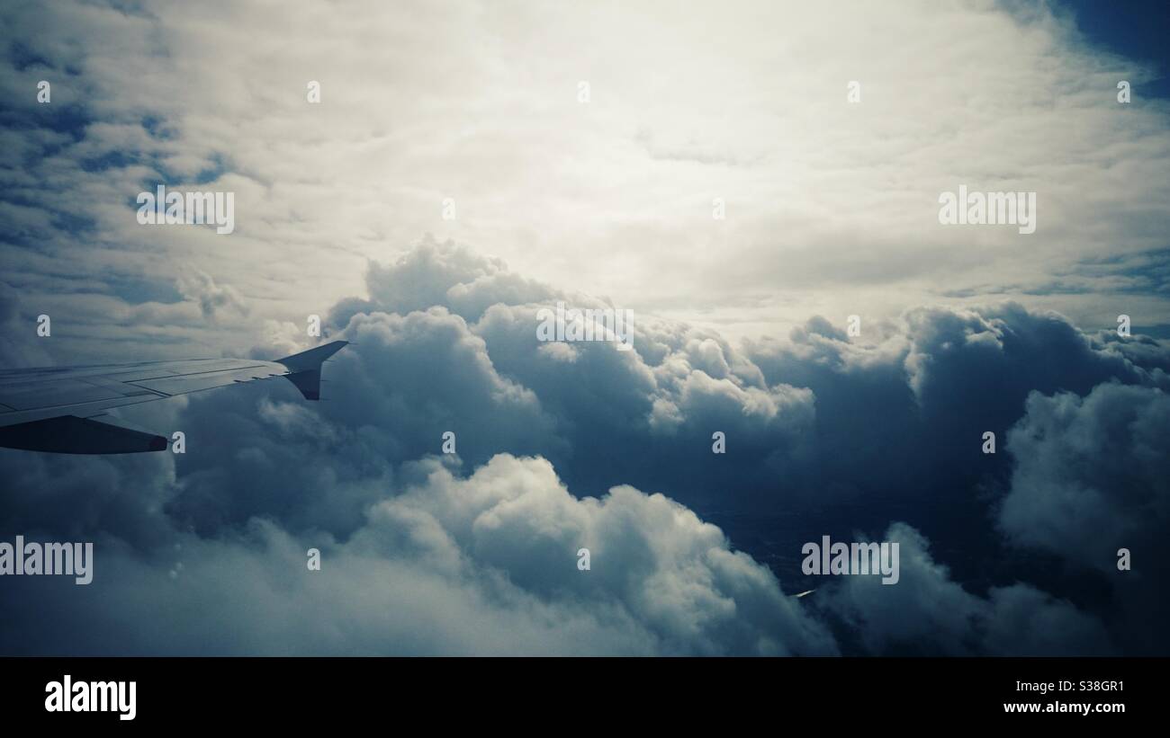 A photograph of beautiful fluffy white clouds from an aeroplane above. Stock Photo
