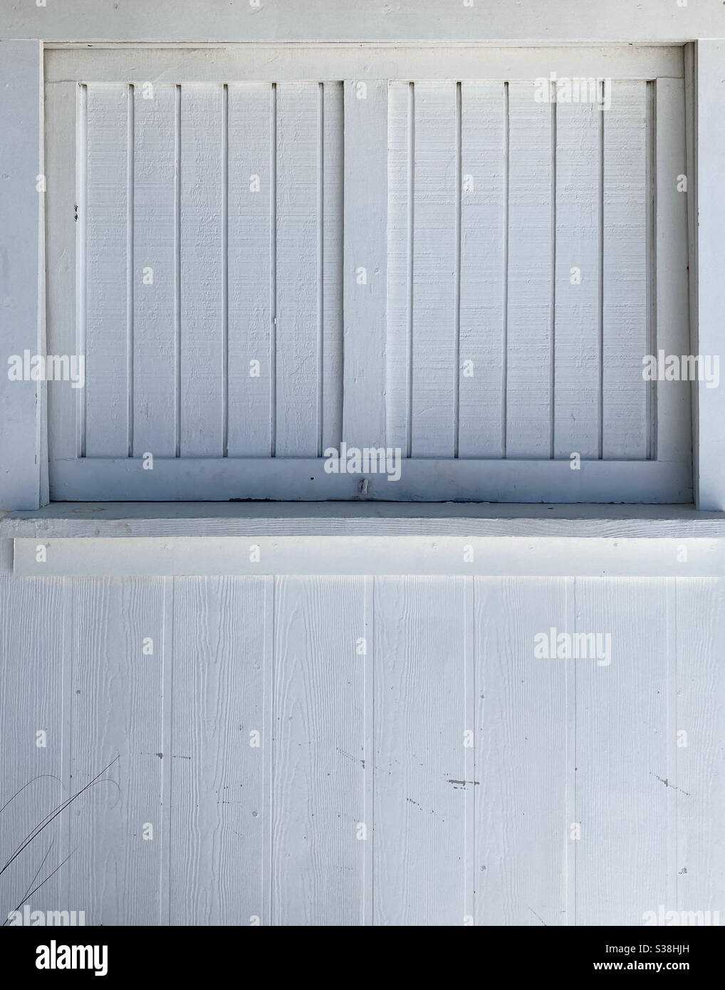 Solid white wood windows on outside building - Smartphone Captured Stock Image