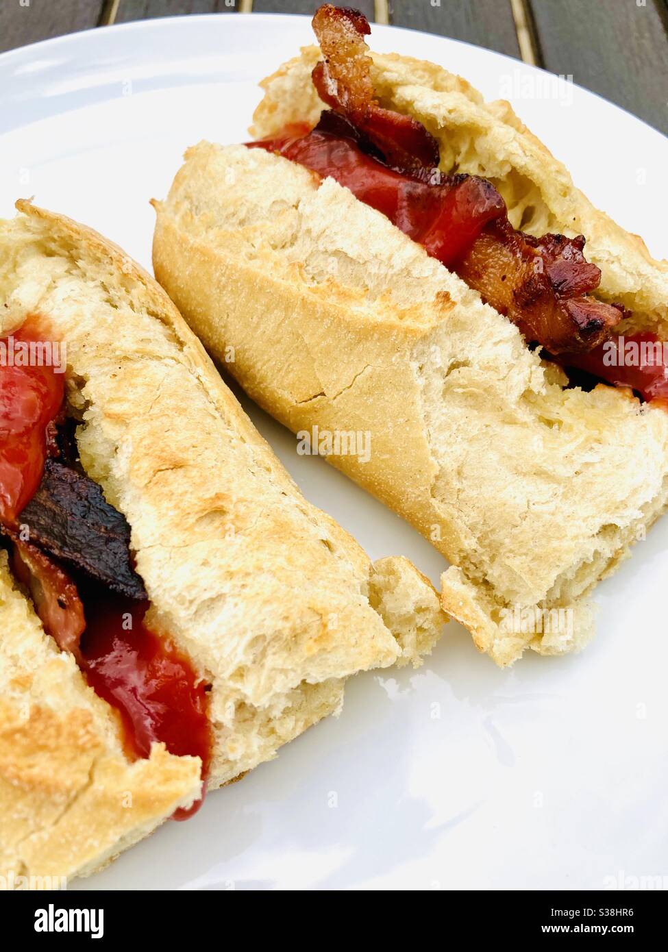 Bacon butty on white baguette Stock Photo Alamy