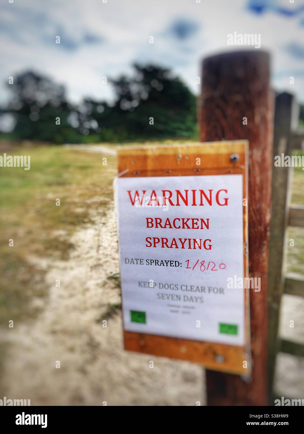 Warning bracken spraying, Sutton Heath, Suffolk, England. - Smartphone Captured Stock Image