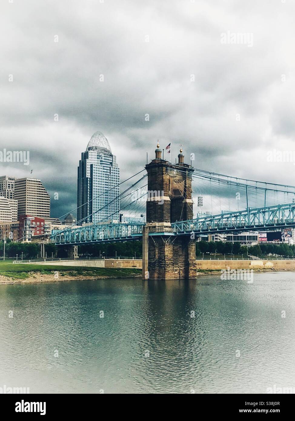 Suspension bridge tower and high rise in Ohio River in Cincinnati - Smartphone Captured Stock Image