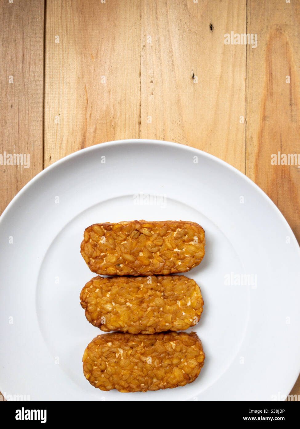 Three tempeh on a white plate Stock Photo Alamy