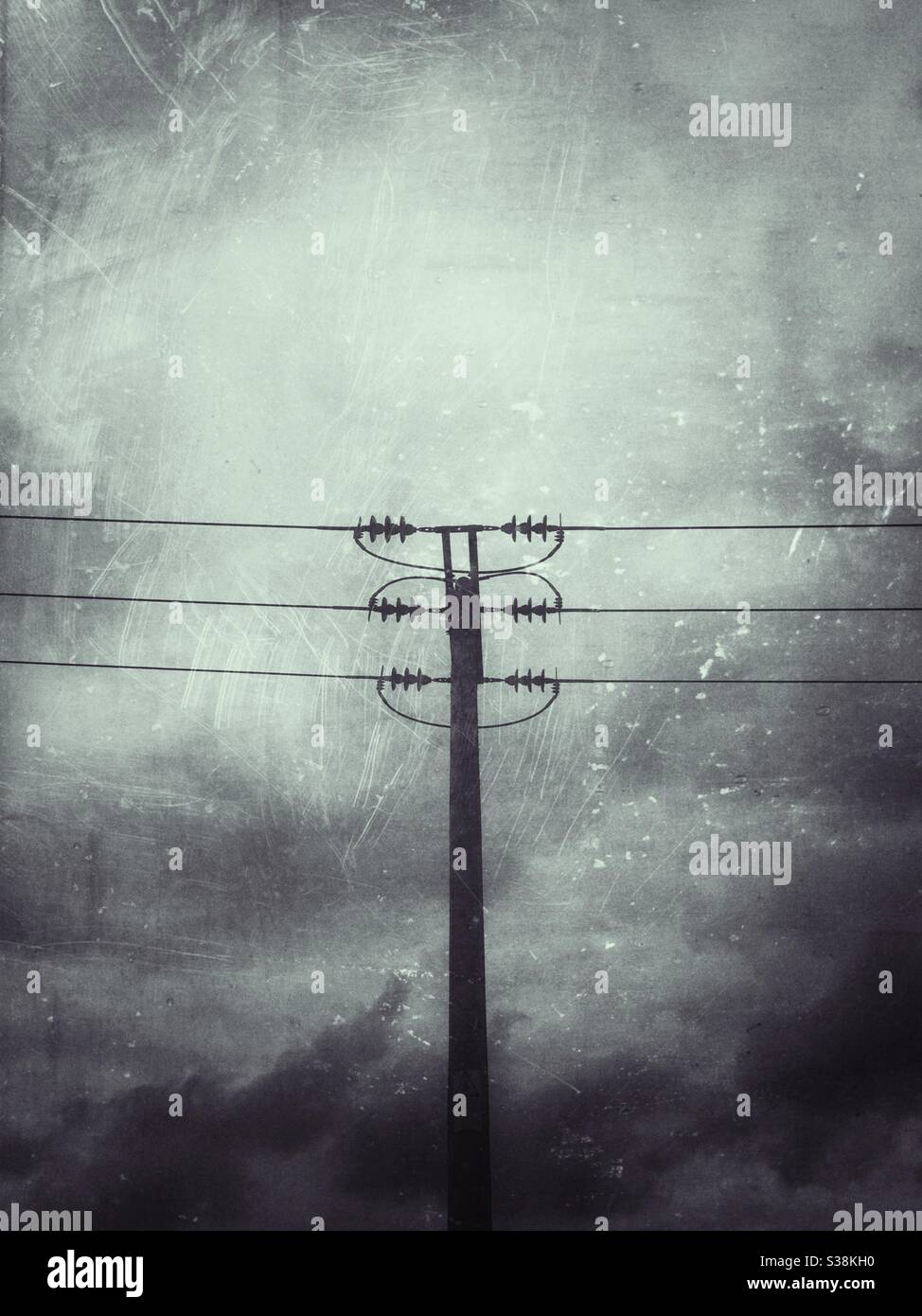 Silhouette of overhead power line with scratch-grunge effect added. - Smartphone Captured Stock Image