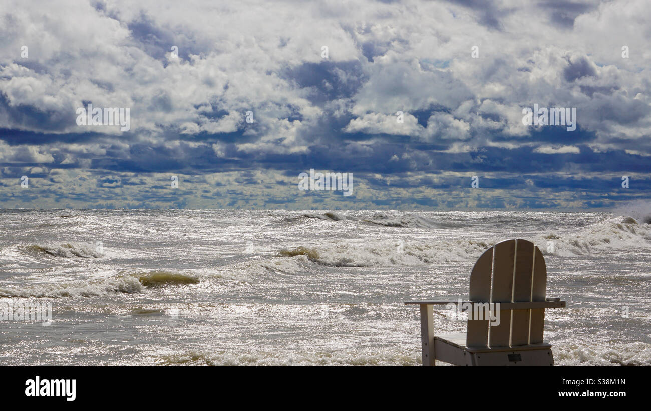 Empty chair looking out at Lake Michigan Stock Photo