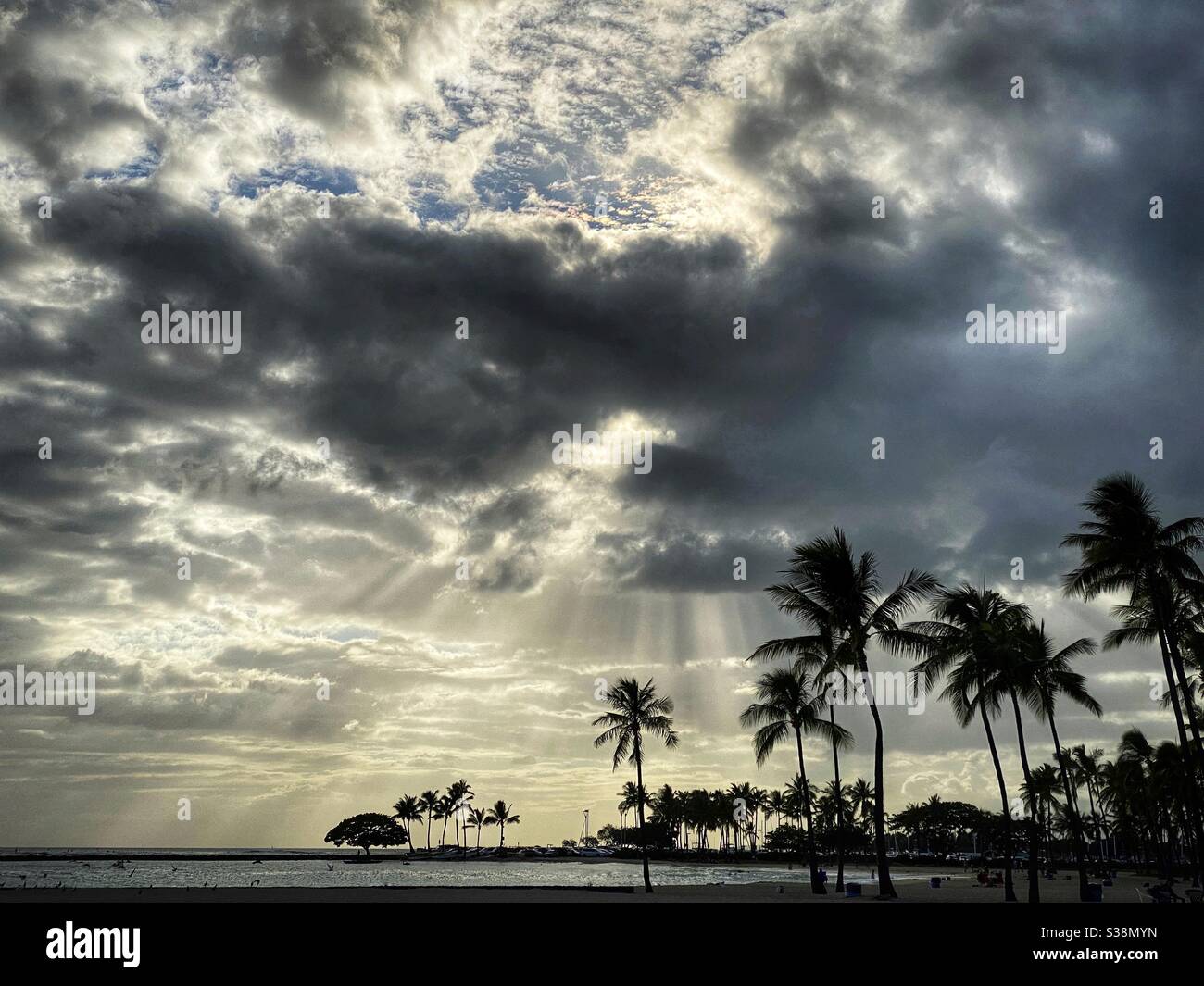 Sunlight streaming through clouds in a tropical landscape - Smartphone Captured Stock Image