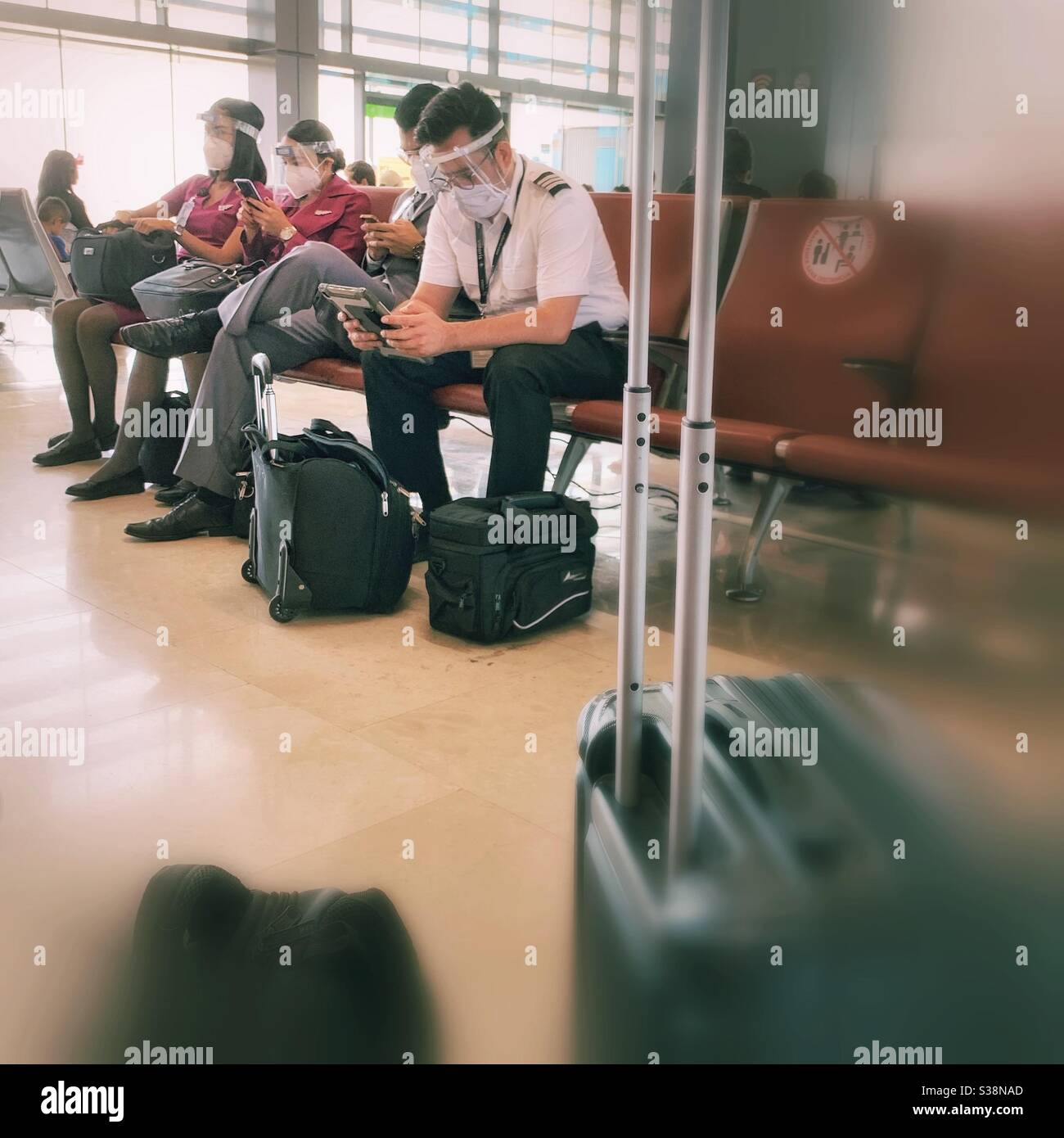 A Volaris flight crew waits for their airplane to arrive in Tijuana, México. Stock Photo