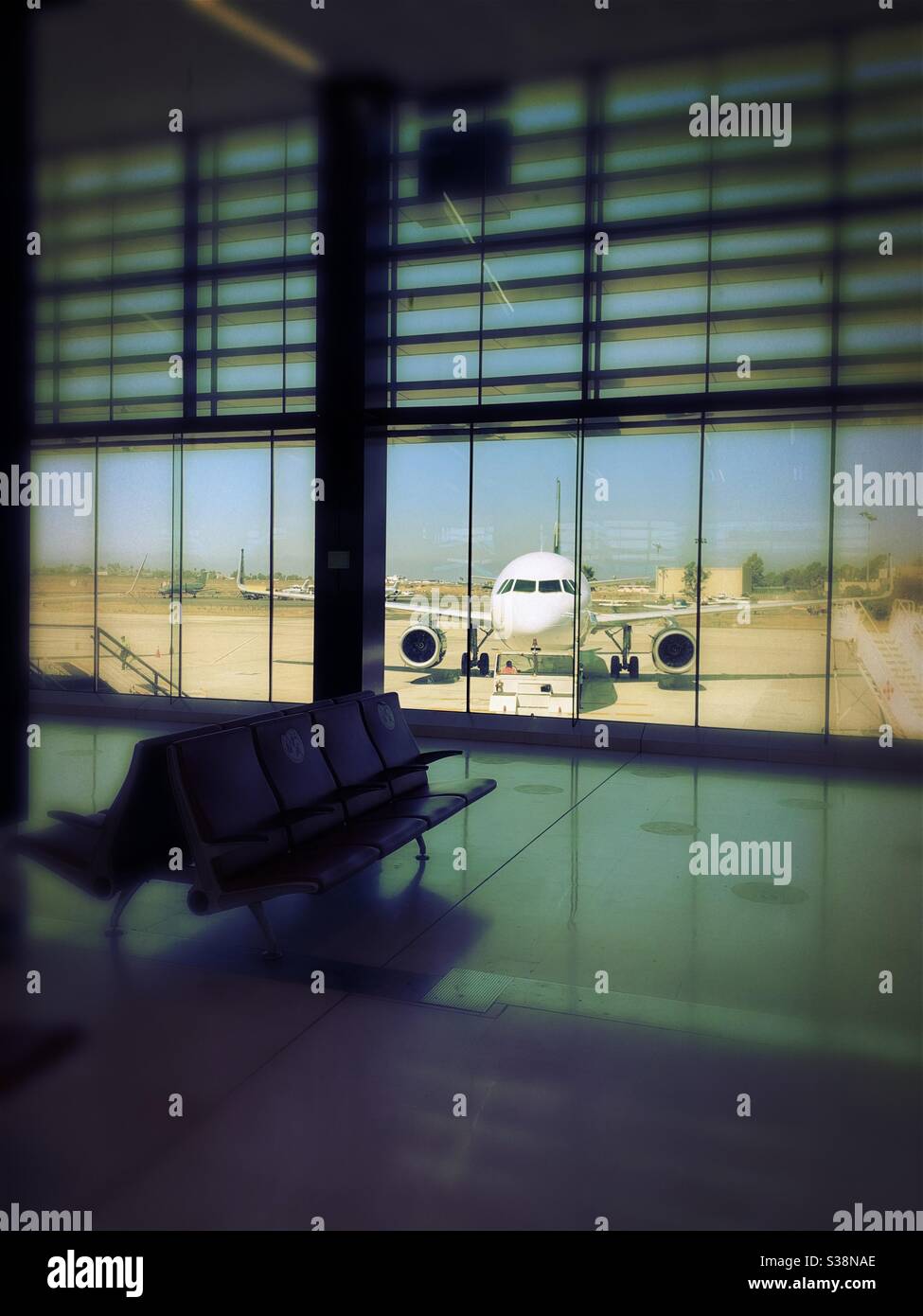 View of an airplane from inside the airport waiting area in Tijuana, México. Stock Photo