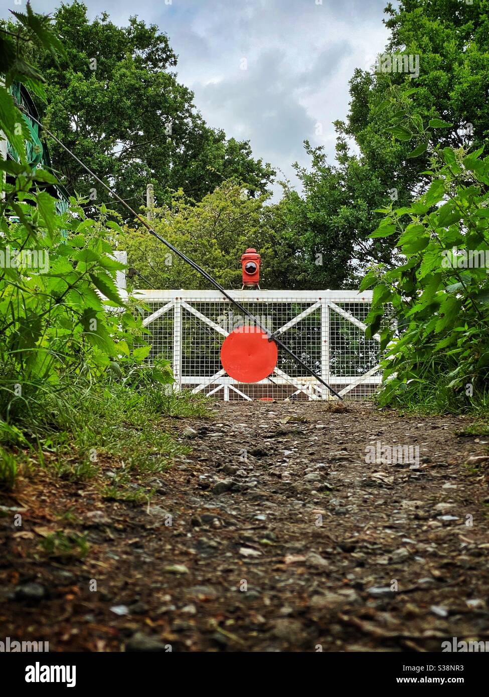An old wooden railway level crossing gate in Essex Stock Photo