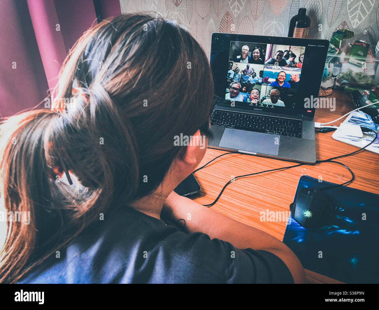 A lady joins a video conference call for a family meeting. - Smartphone Captured Stock Image