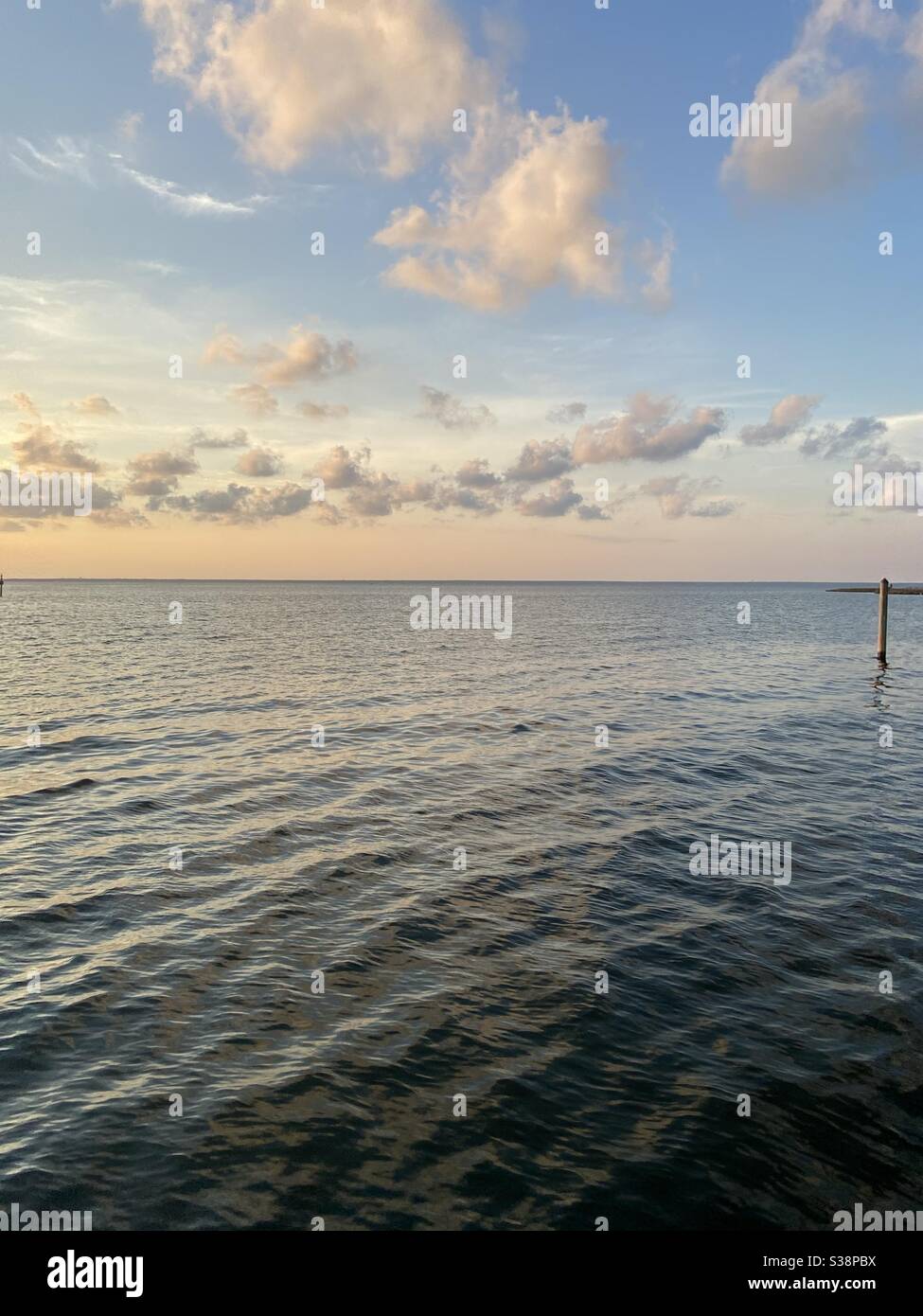 Soft sunset skies with clouds over bay water Stock Photo - Alamy