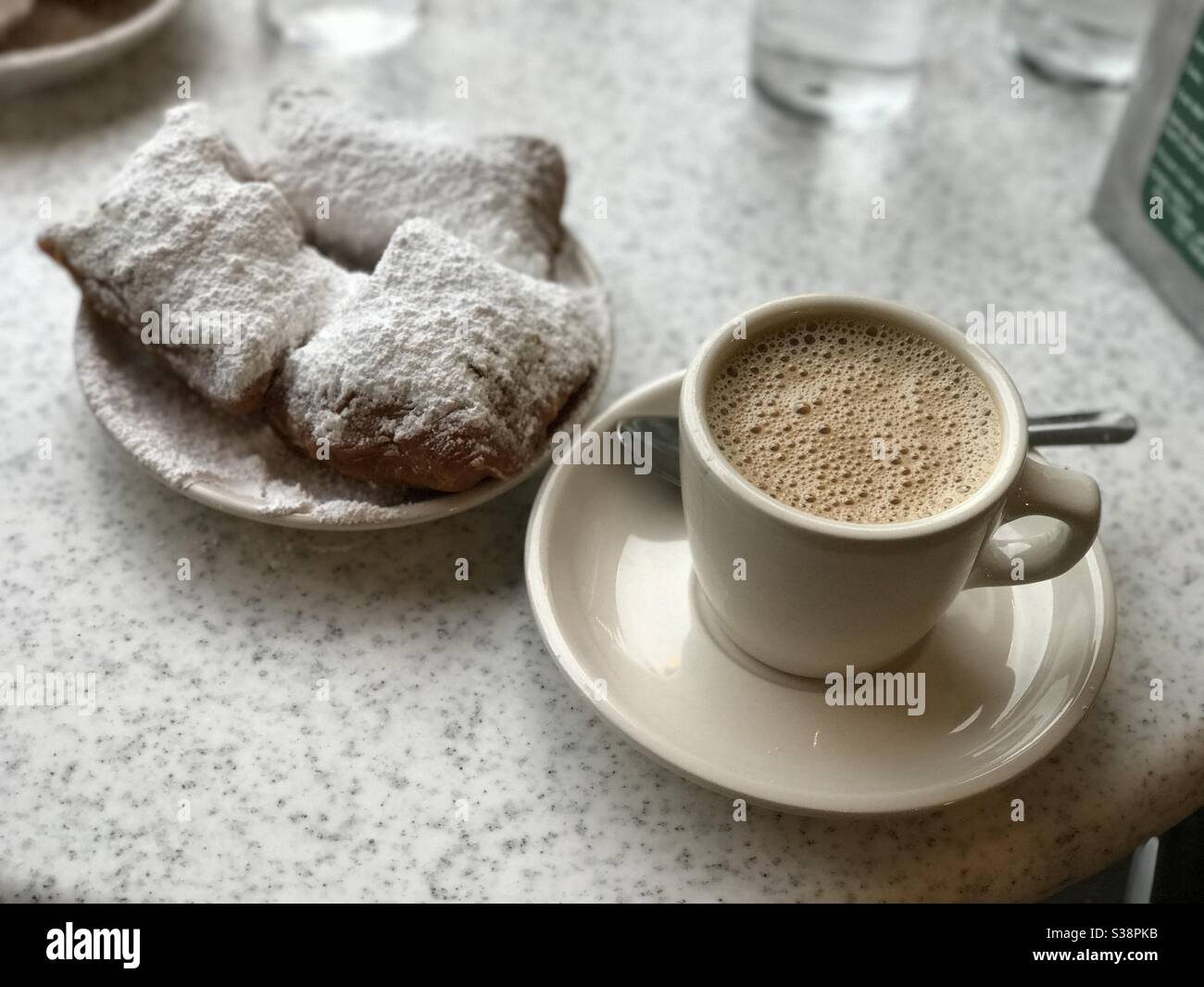 Beignets and coffee at a cafe in New Orleans. Stock Photo
