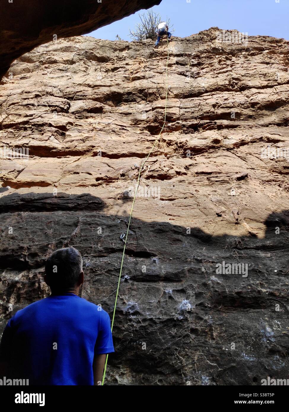 A climber prevail on granite walls at Badami, Karnataka, India Stock Photo