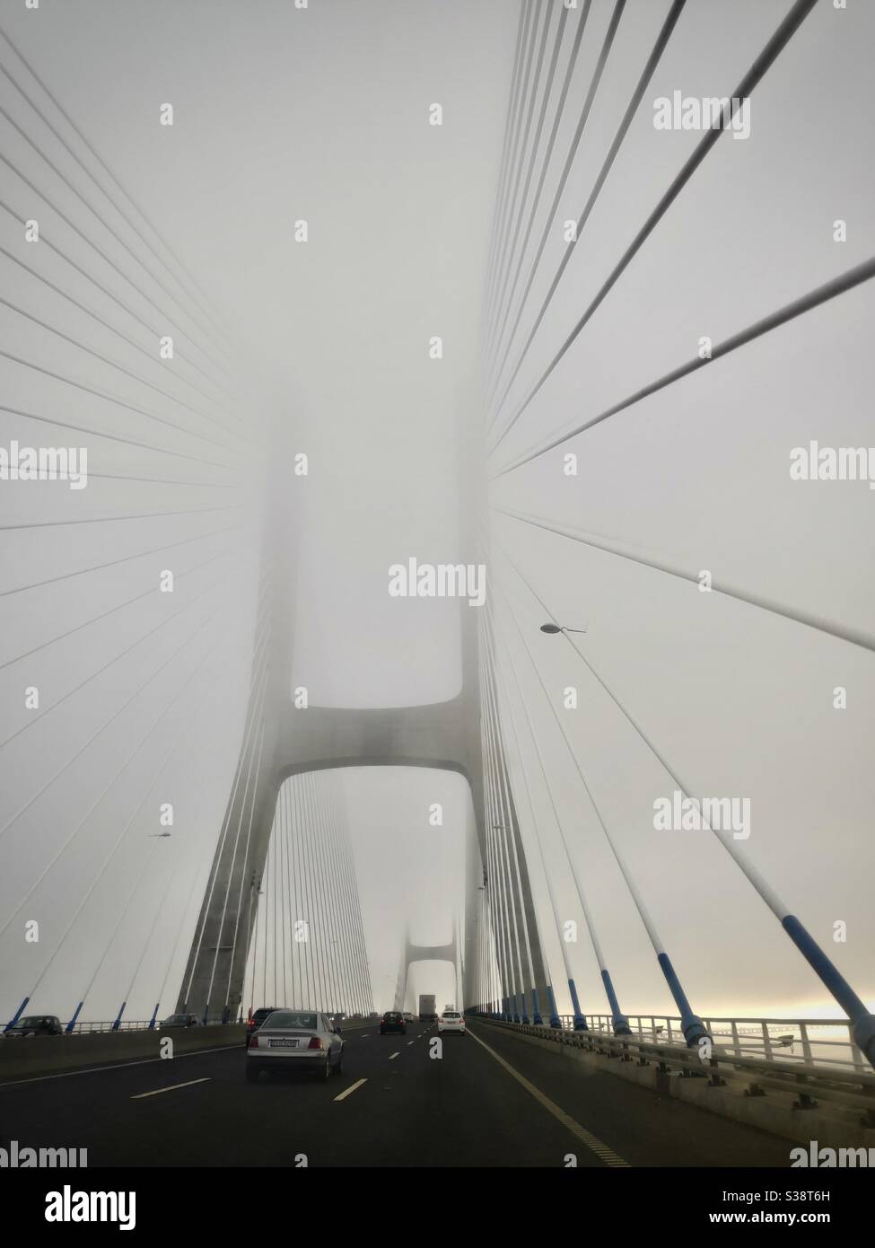 Vasco da Gamma bridge in fog at early morning in Lisbon, Portugal - Smartphone Captured Stock Image
