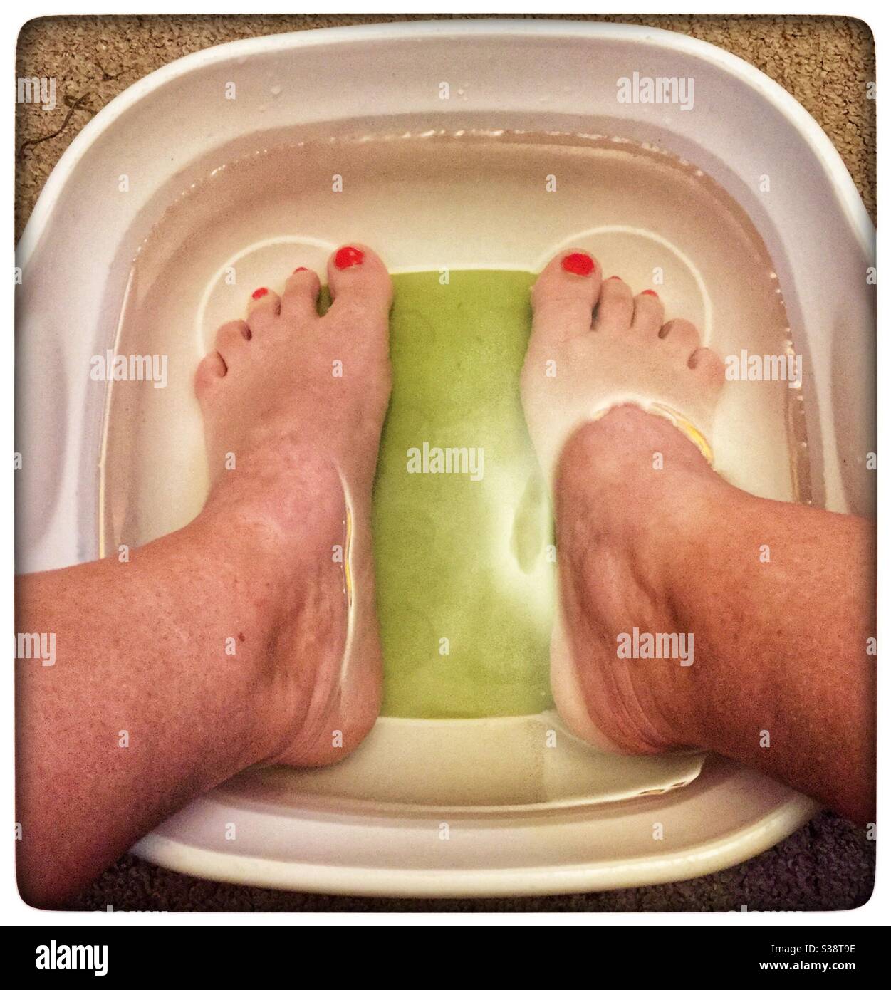 Feet in bowl of water - Smartphone Captured Stock Image