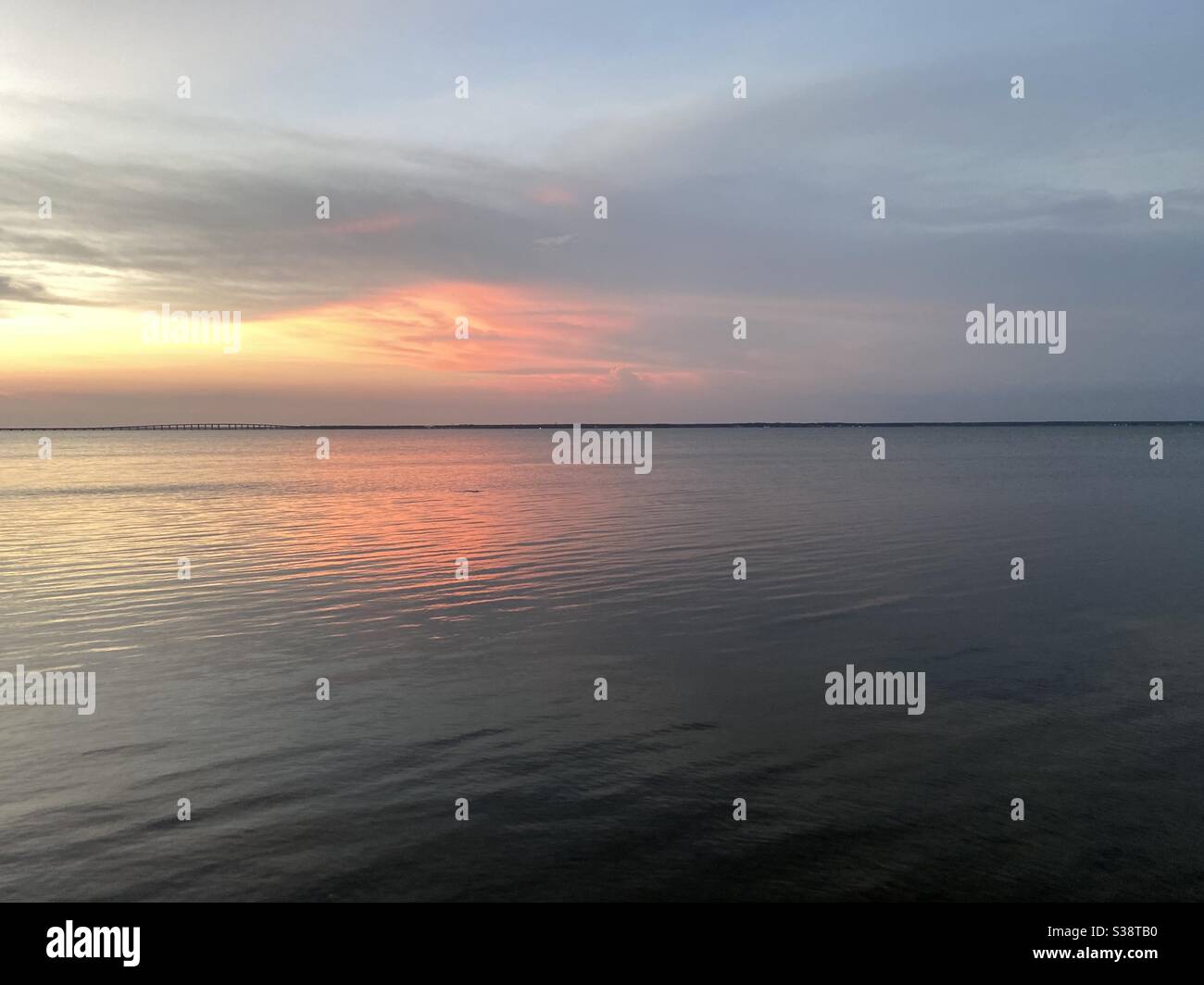 Colorful sunset skies reflecting onto bay water Stock Photo - Alamy