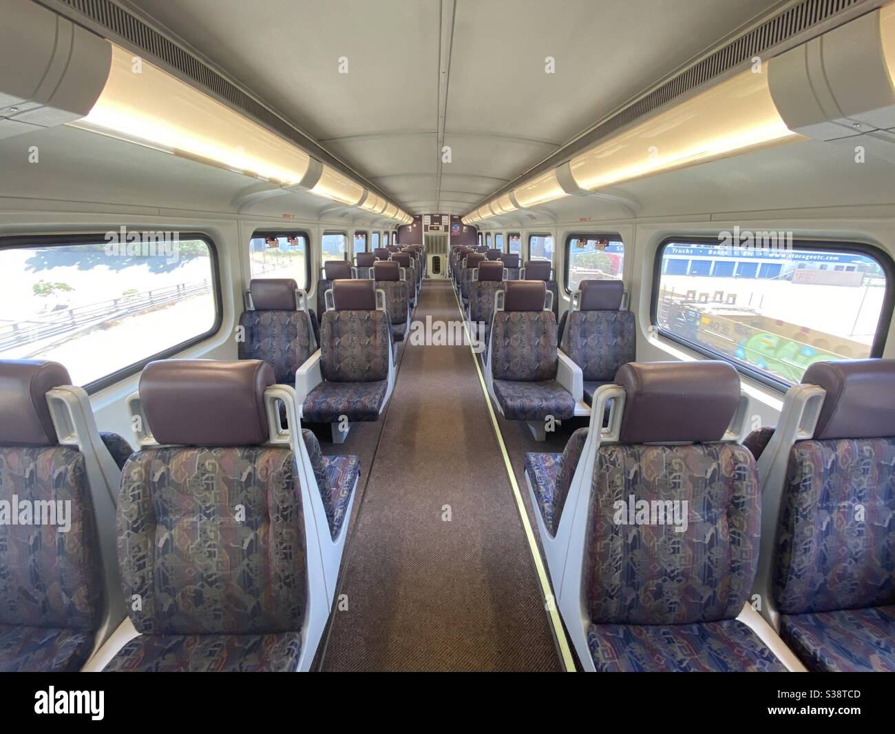 LOS ANGELES, CA, JUN 2020: high angle view, interior of empty Metrolink train car, light rail system used by commuters in Southern California - Smartphone Captured Stock Image