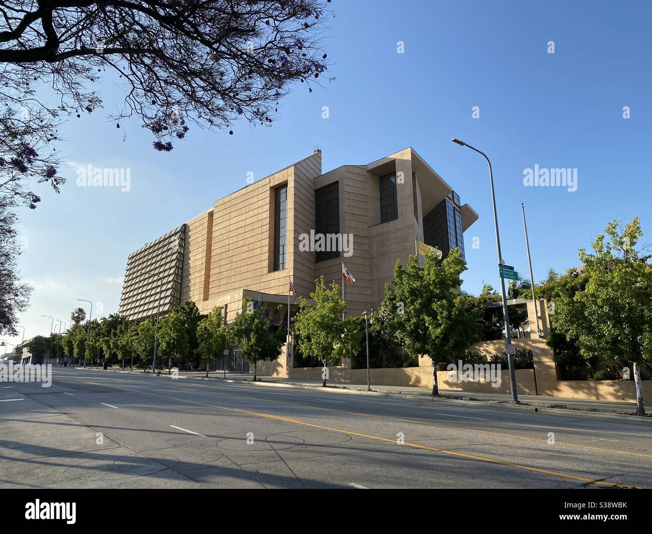 LOS ANGELES, CA, JUN 2020: part of the Cathedral of Our Lady of The Angels, modern Catholic cathedral building in Downtown, late afternoon, framed by foreground tree - Smartphone Captured Stock Image