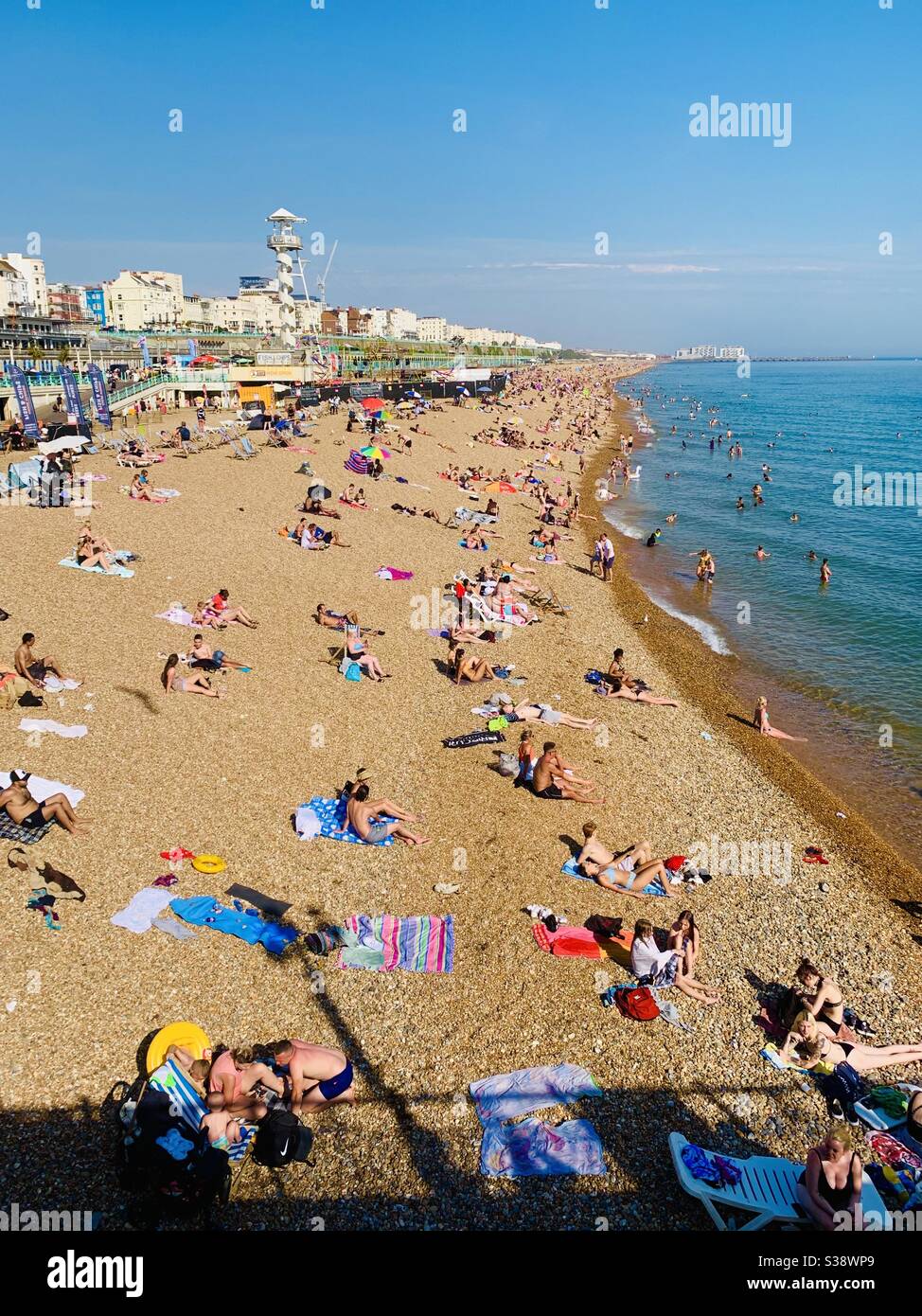 Brighton, UK - 10 August 2020: The beach busy with sunseekers in the summer heatwave. Stock Photo