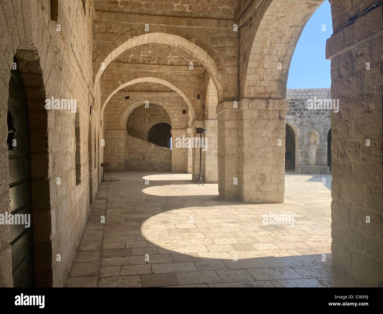 Stone Arches at Dubrovnik old town with shadows Stock Photo