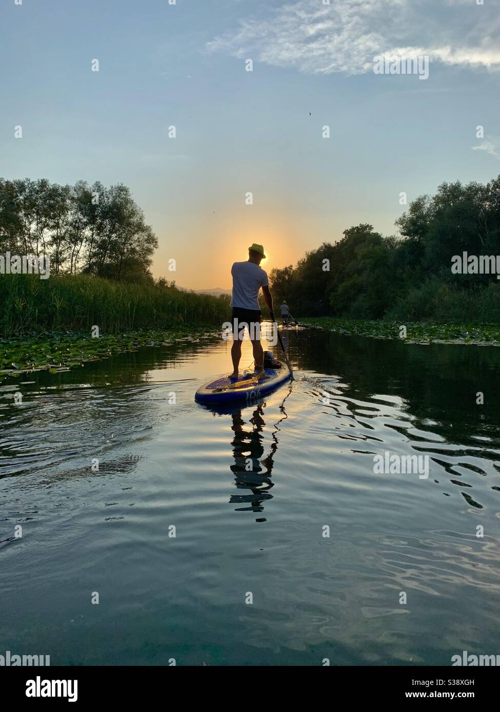 Silhouette of man on stand up paddle board in river in Montenegro - Smartphone Captured Stock Image