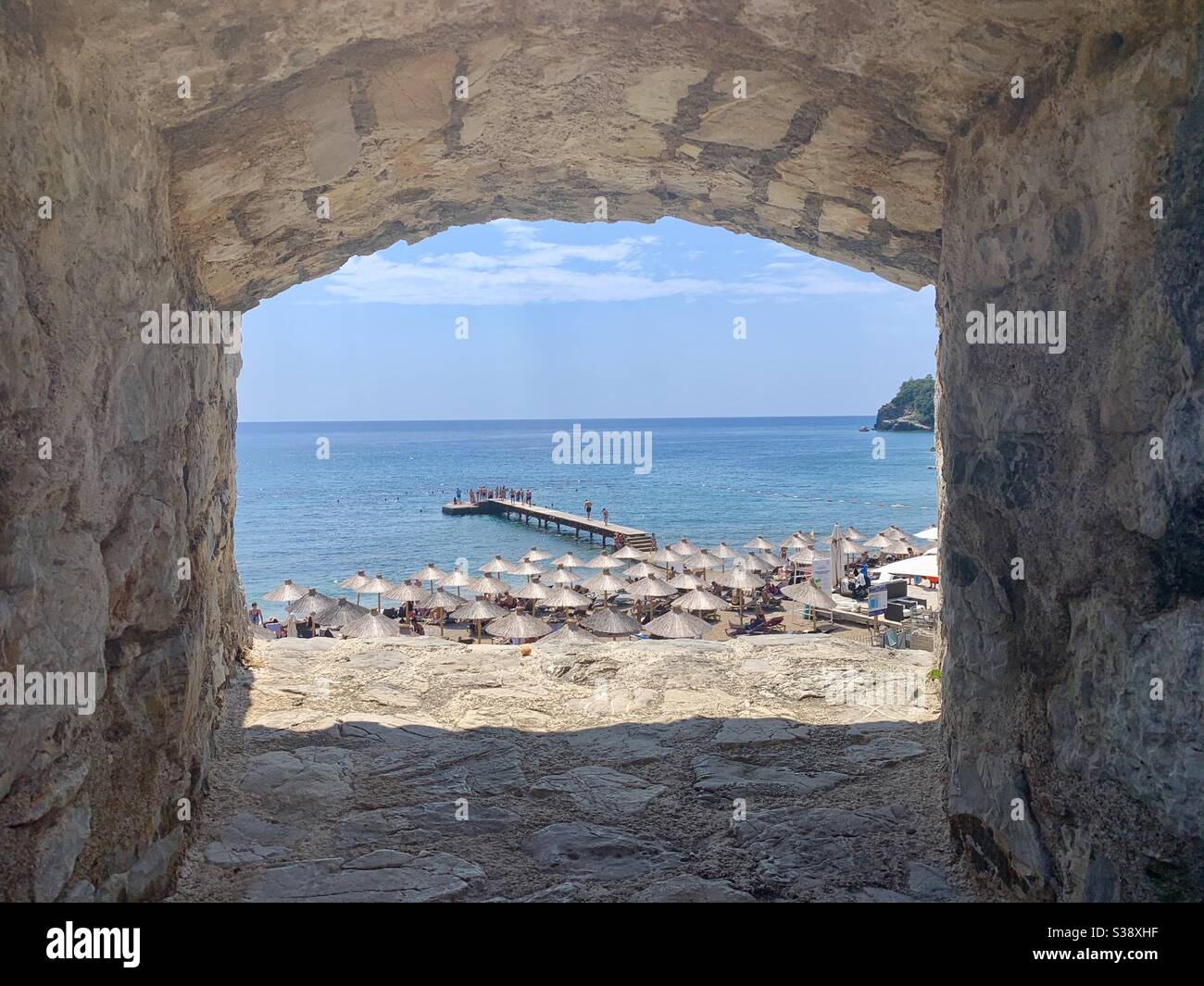 View through city wall towards budva beach - Smartphone Captured Stock Image