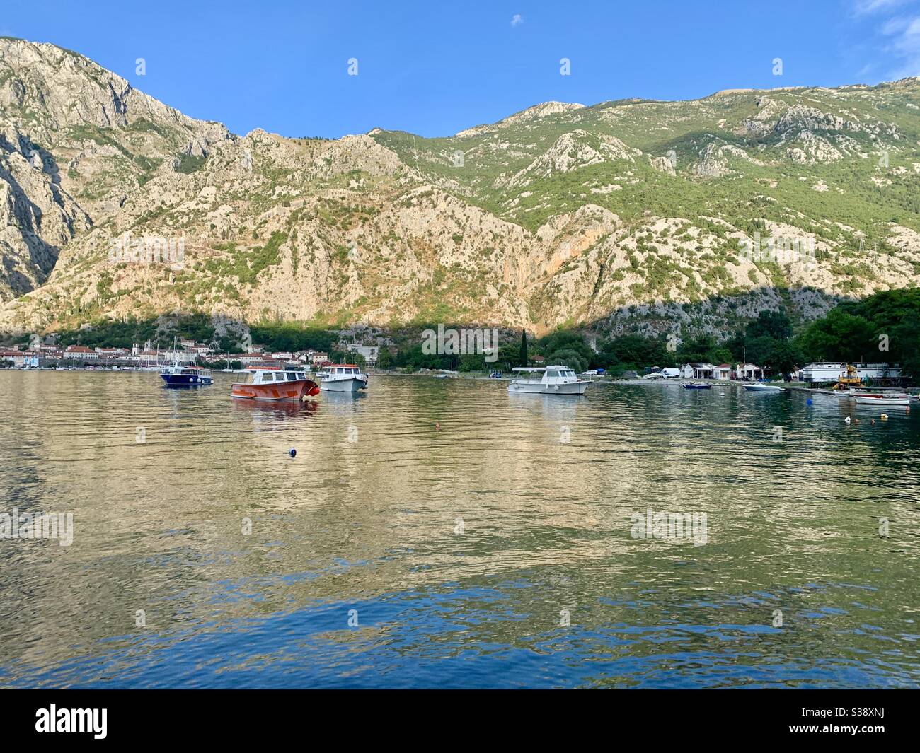 Beautiful lake scene in Montenegro with boats and mountains - Smartphone Captured Stock Image