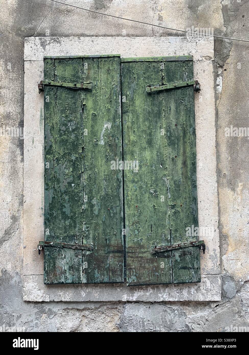 Rustic old shutter window with flaking paint Stock Photo