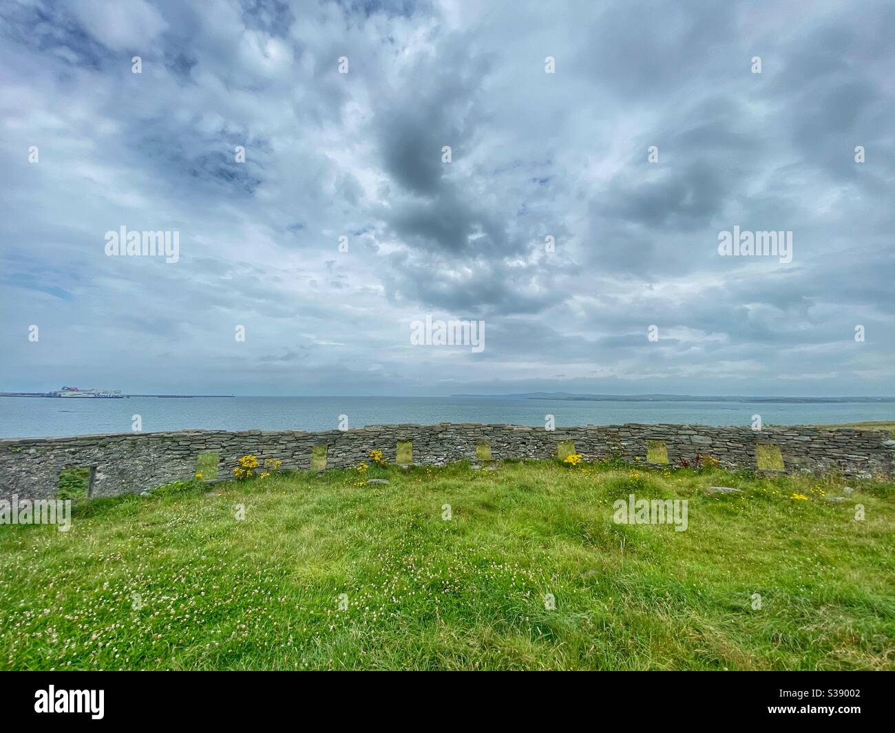 View across the sea from the ruins of a naval Battery at Penrhos Coastal Park, Holyhead, Anglesey, north wales. - Smartphone Captured Stock Image
