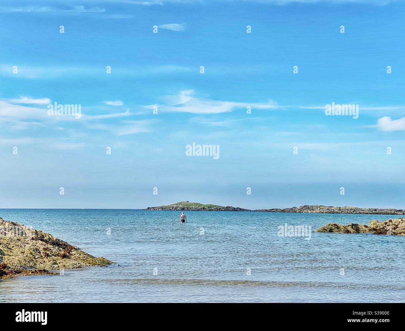 Swimmer on Traeth Cymyran, Rhosneigr, Anglesey, on a beautiful sunny and calm morning in August - Smartphone Captured Stock Image