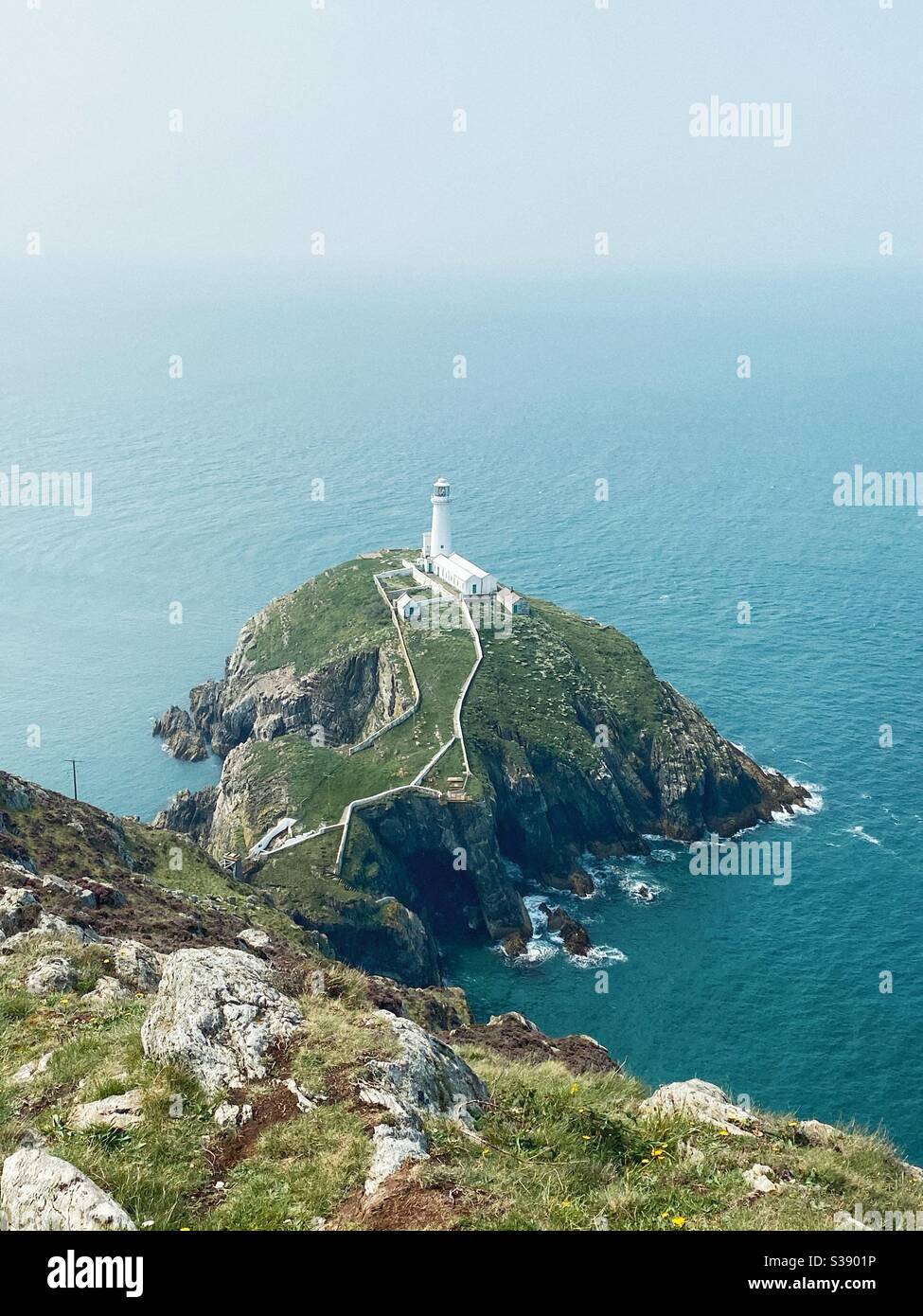 South stack lighthouse, Holyhead, Anglesey, north wales. Looking down from above from the mainland cliff. Portrait composition. Empty space at the top - Smartphone Captured Stock Image